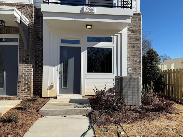 entrance to property with a balcony and central AC