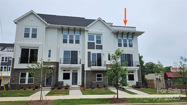 1229 E 34th St Unit Csw0421, Charlotte, NC 28205 - view of front of property with a balcony, fence, central AC, and board and batten siding