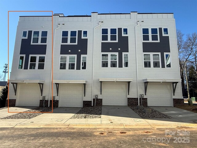 1229 E 34th St Unit Csw0421, Charlotte, NC 28205 - view of front of house with brick siding and a garage
