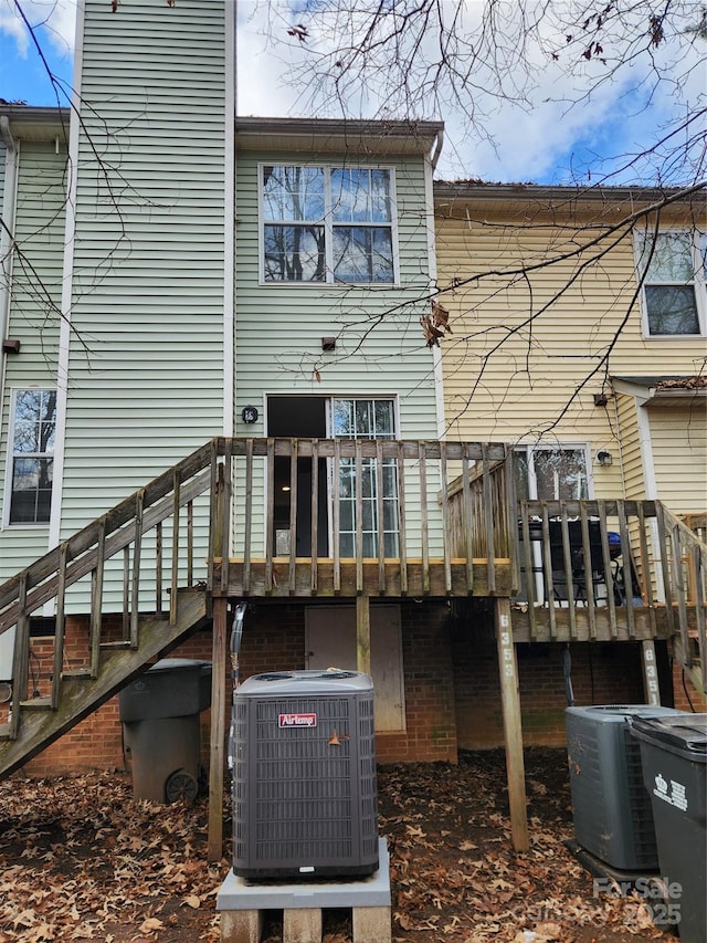 back of property with a wooden deck and central AC unit