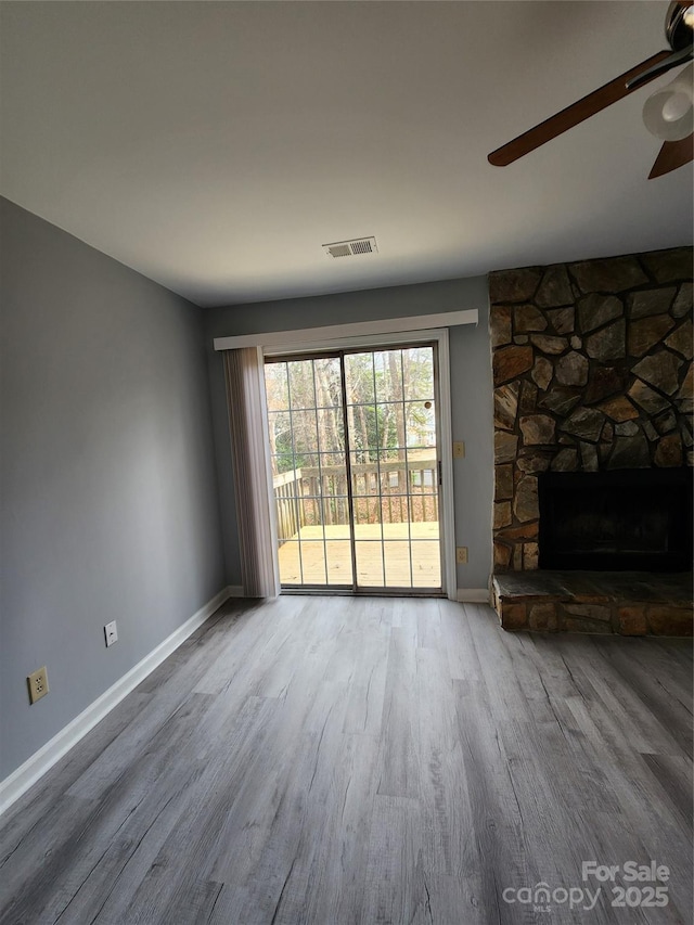 unfurnished living room with a fireplace and hardwood / wood-style floors