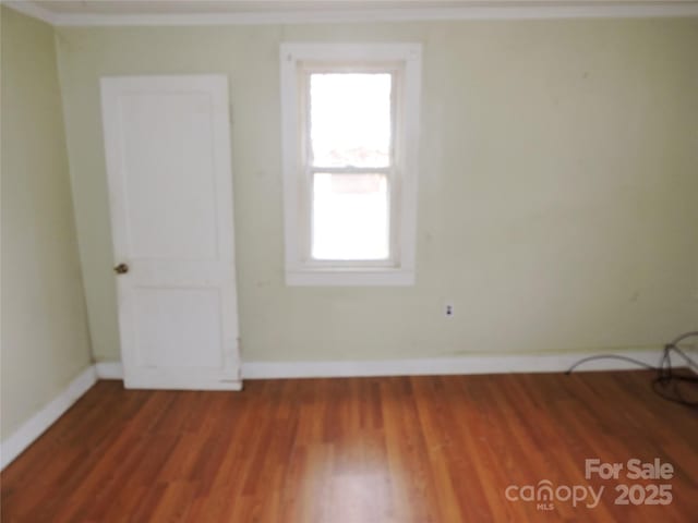 spare room featuring wood-type flooring