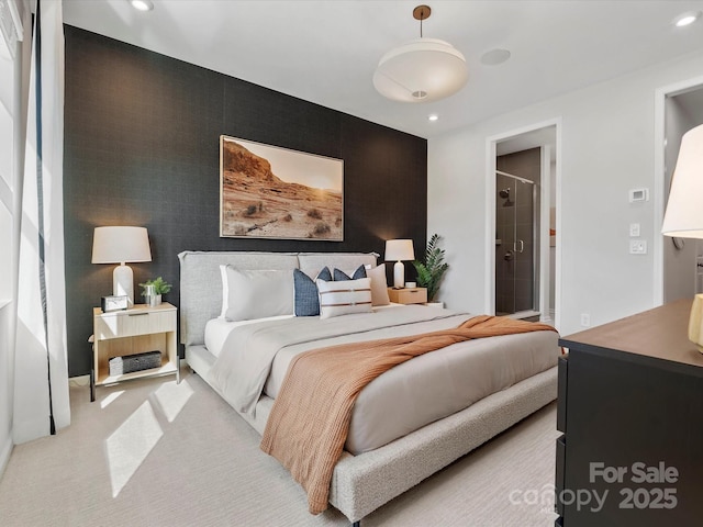 bedroom with light carpet, ensuite bath, and recessed lighting