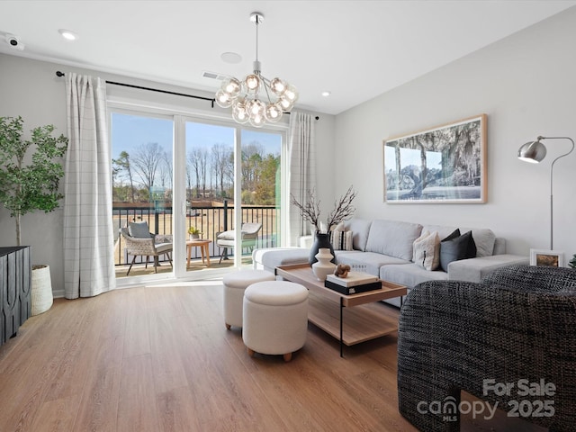 living room featuring an inviting chandelier, visible vents, wood finished floors, and recessed lighting