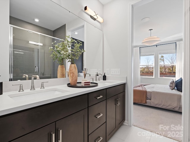 ensuite bathroom with a sink, a shower stall, ensuite bathroom, and double vanity