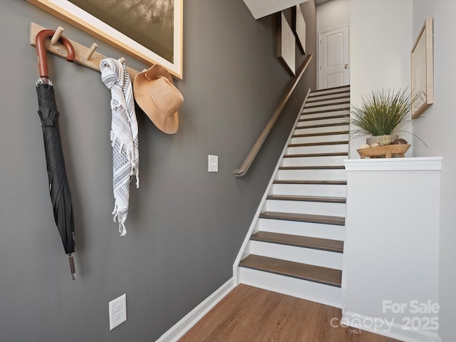 stairway with baseboards and wood finished floors