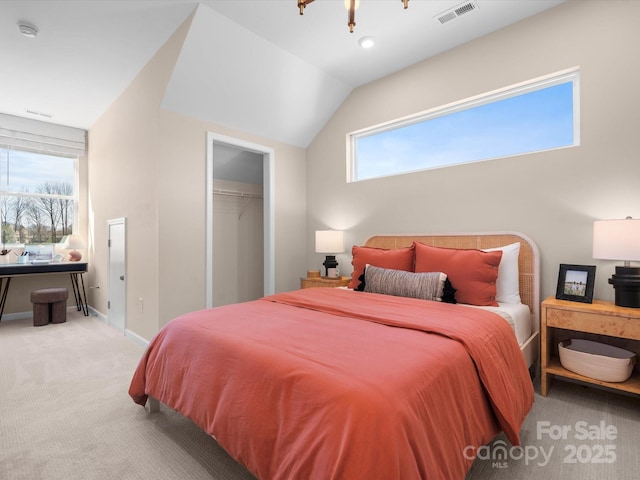 carpeted bedroom with a closet, visible vents, baseboards, and lofted ceiling