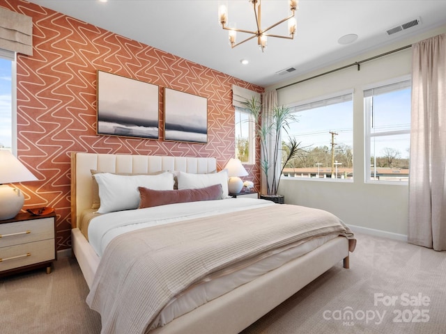 bedroom with visible vents, a notable chandelier, carpet flooring, wallpapered walls, and baseboards