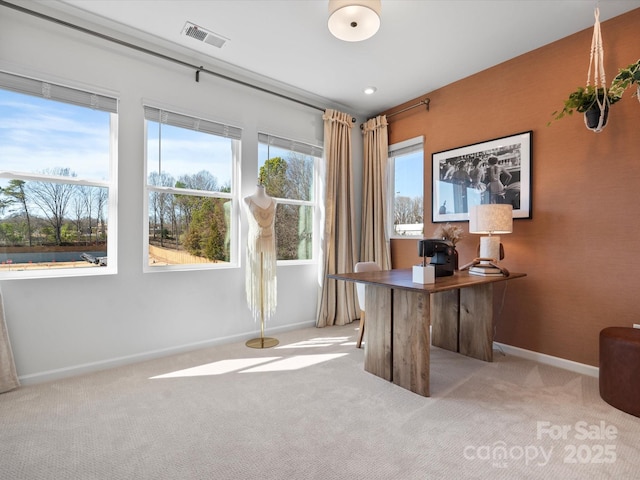 office area with baseboards, visible vents, carpet floors, and a healthy amount of sunlight