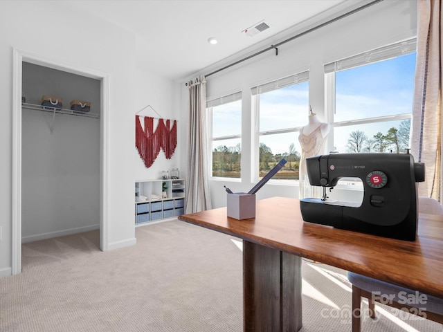 carpeted office featuring visible vents and baseboards