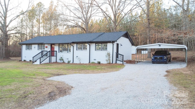 view of front of home with a front yard and a carport