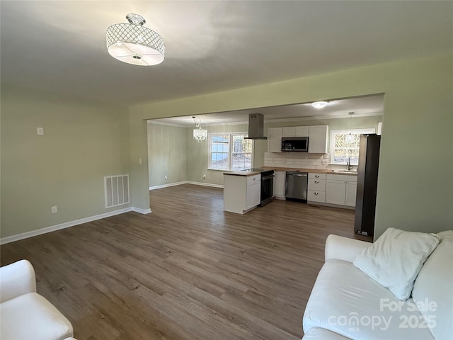 living room featuring a chandelier, dark wood-type flooring, and sink