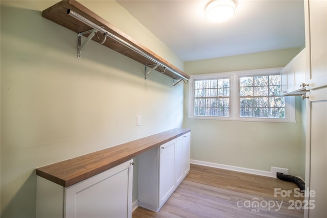 spacious closet featuring light hardwood / wood-style flooring