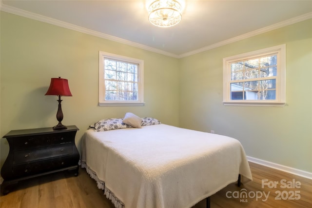 bedroom with hardwood / wood-style floors and ornamental molding