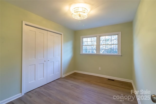 unfurnished bedroom with light hardwood / wood-style floors and a closet