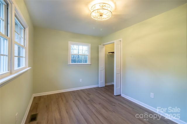 spare room with hardwood / wood-style flooring