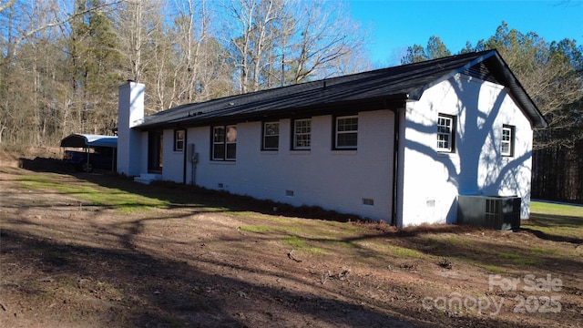 view of side of home featuring cooling unit