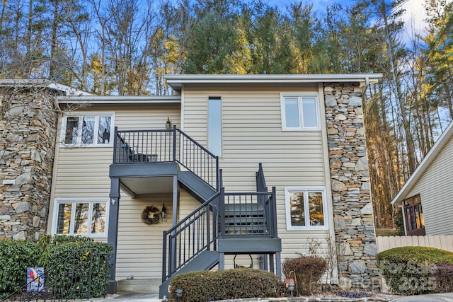 back of property with a balcony