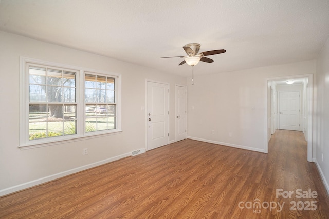 spare room featuring ceiling fan and wood-type flooring