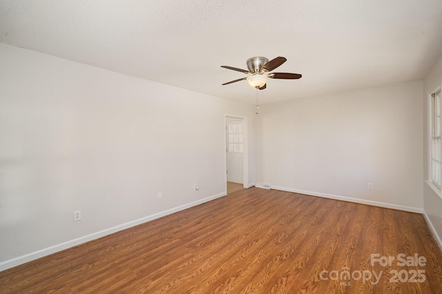 empty room featuring hardwood / wood-style flooring and ceiling fan