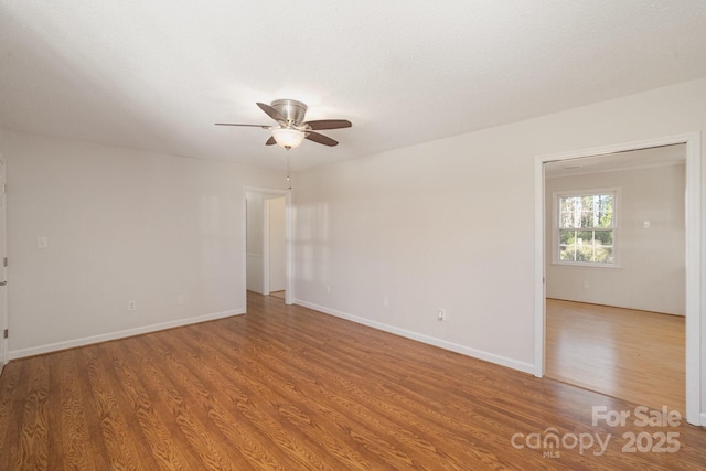 spare room with hardwood / wood-style floors and ceiling fan