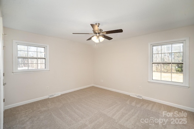 empty room with ceiling fan and carpet floors