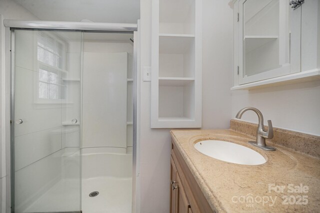 bathroom with vanity and an enclosed shower