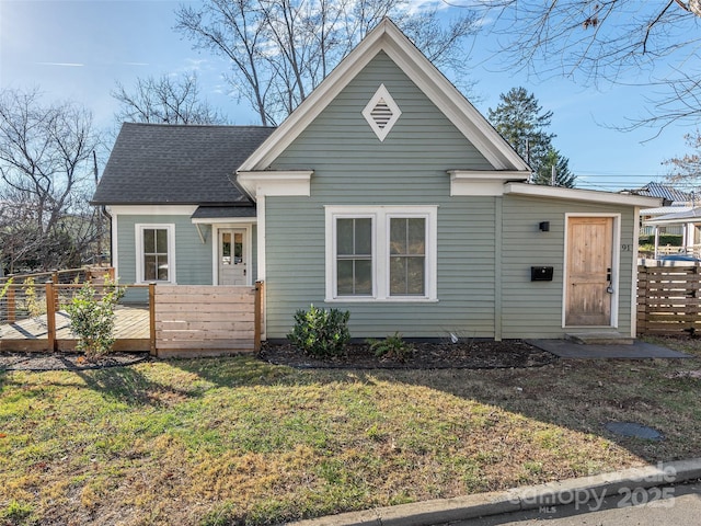 view of front of house featuring a deck and a front yard