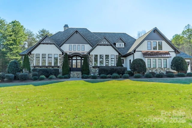 view of front of property featuring a front yard and french doors