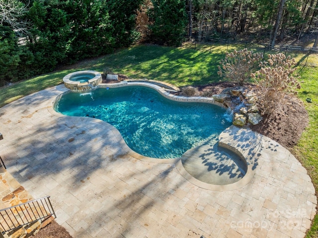 view of pool with a yard, a patio, and an in ground hot tub