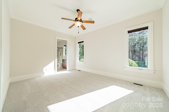 unfurnished room with light carpet, ornamental molding, and ceiling fan