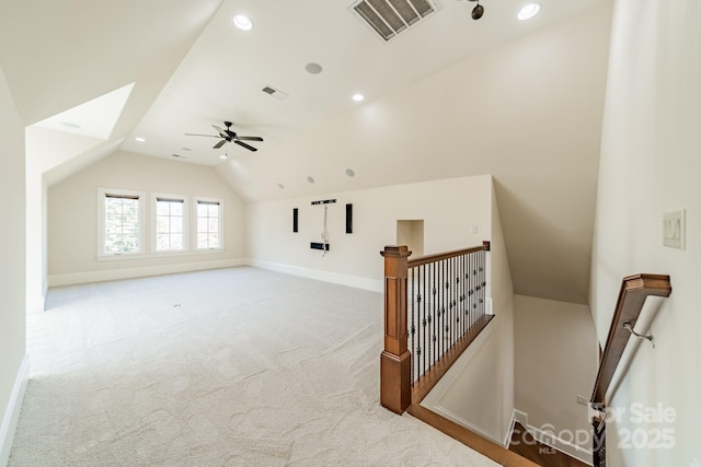 bonus room featuring lofted ceiling, light colored carpet, and ceiling fan