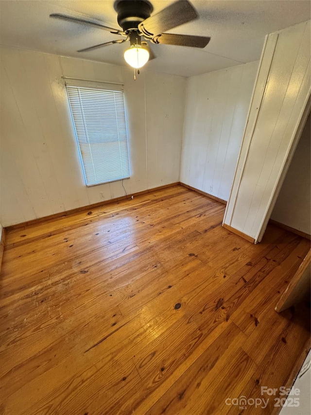 spare room with light hardwood / wood-style flooring and ceiling fan