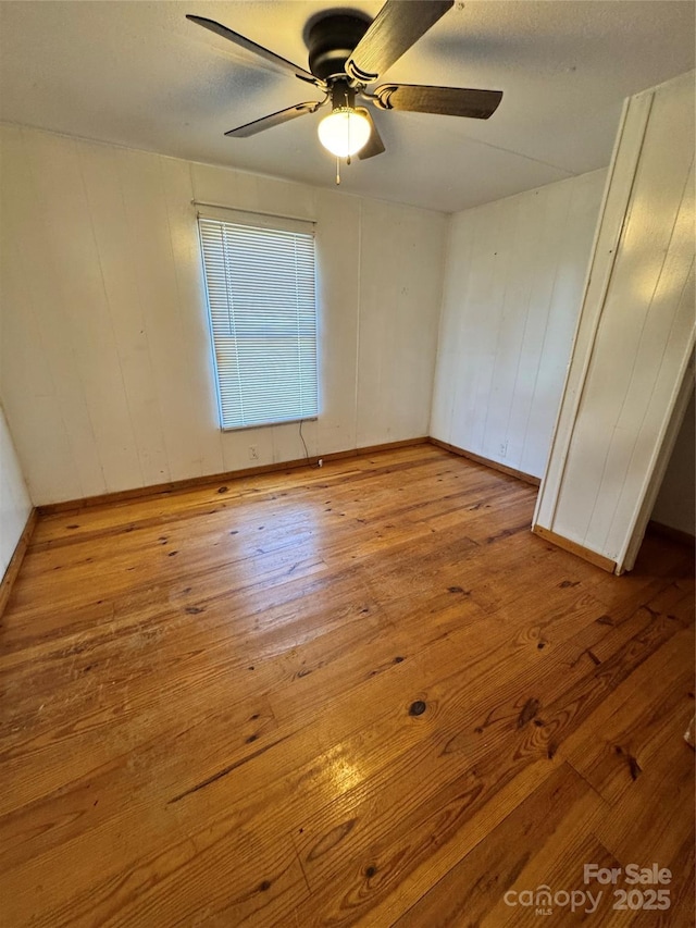 spare room featuring ceiling fan and light wood-type flooring