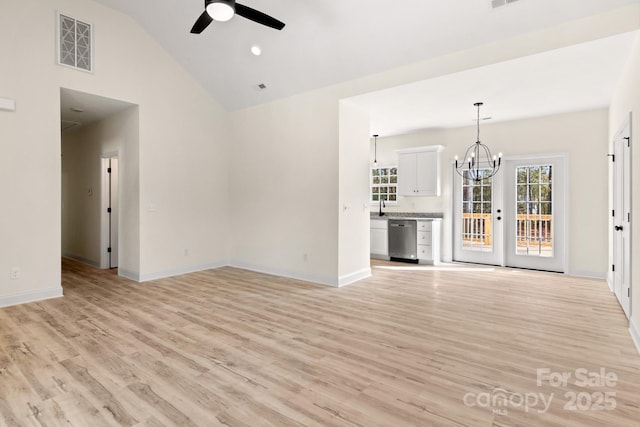 unfurnished living room featuring light wood-type flooring, baseboards, visible vents, and ceiling fan with notable chandelier