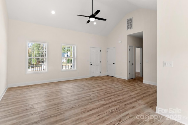 unfurnished living room featuring light wood finished floors, baseboards, visible vents, a ceiling fan, and high vaulted ceiling