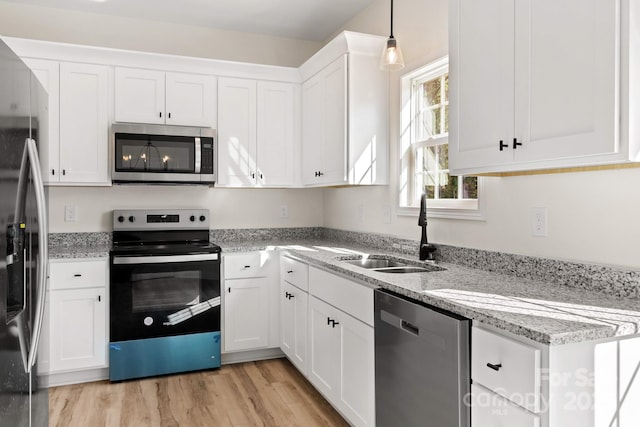 kitchen featuring white cabinetry, appliances with stainless steel finishes, and a sink