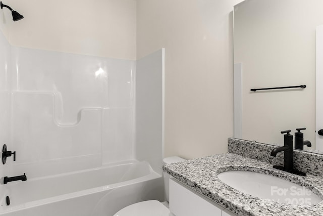 bathroom featuring toilet, shower / washtub combination, and vanity