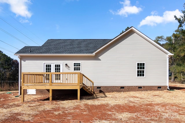 back of house featuring crawl space, roof with shingles, and a wooden deck