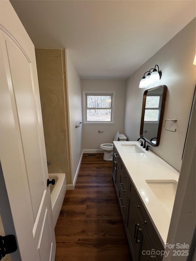 bathroom featuring hardwood / wood-style flooring, vanity, and toilet