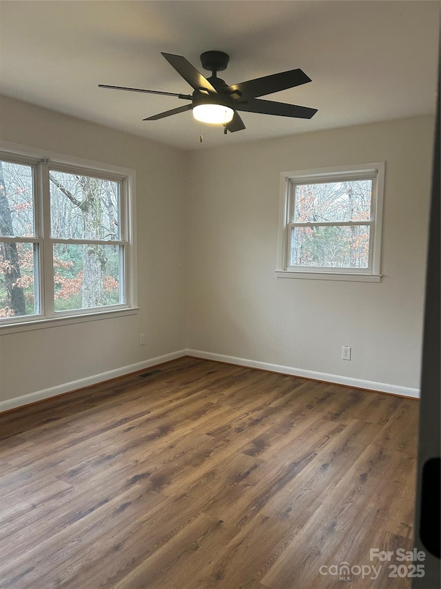 unfurnished room featuring dark hardwood / wood-style flooring and ceiling fan