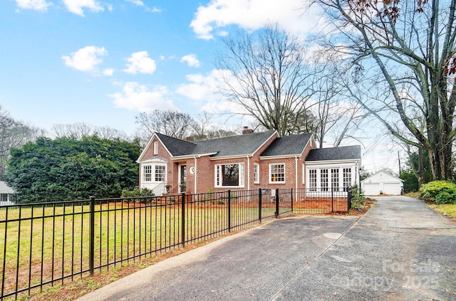 view of front of property with an outdoor structure, a front yard, and a garage