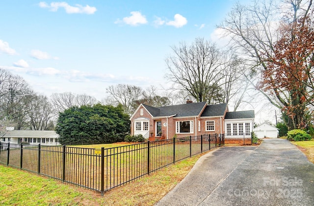 ranch-style home with an outbuilding, a garage, and a front lawn