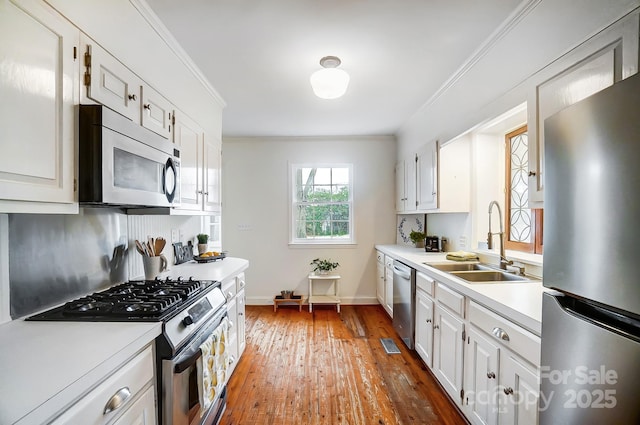 kitchen featuring white cabinets, appliances with stainless steel finishes, and sink