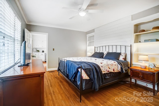 bedroom with ceiling fan, crown molding, and hardwood / wood-style floors