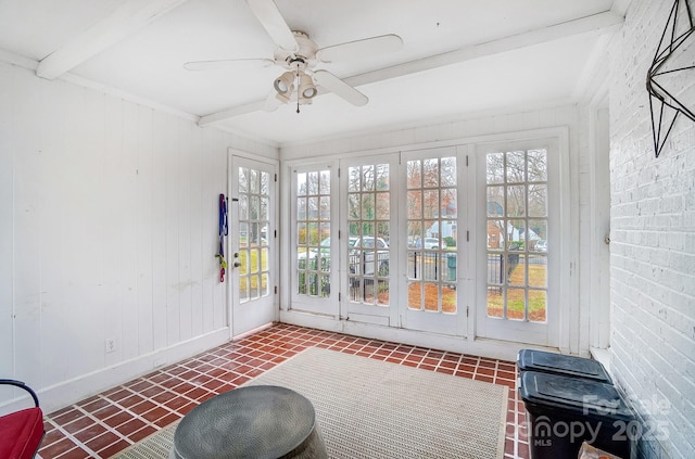 sunroom featuring ceiling fan and beam ceiling