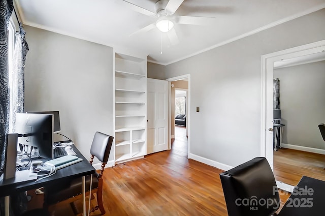 office with hardwood / wood-style flooring, built in features, ceiling fan, and crown molding