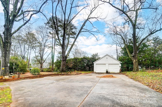 exterior space with a garage and an outbuilding