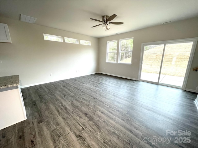 spare room featuring visible vents, baseboards, dark wood finished floors, and a ceiling fan