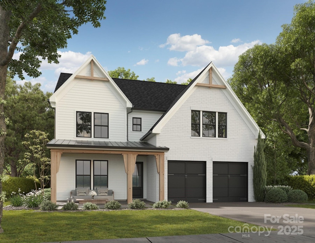 modern farmhouse featuring a porch, a garage, and a front lawn